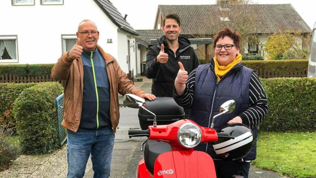 schuhplus-Chefs überbringen gewonnenen E-Roller an Nadine Eichinger aus Bremen